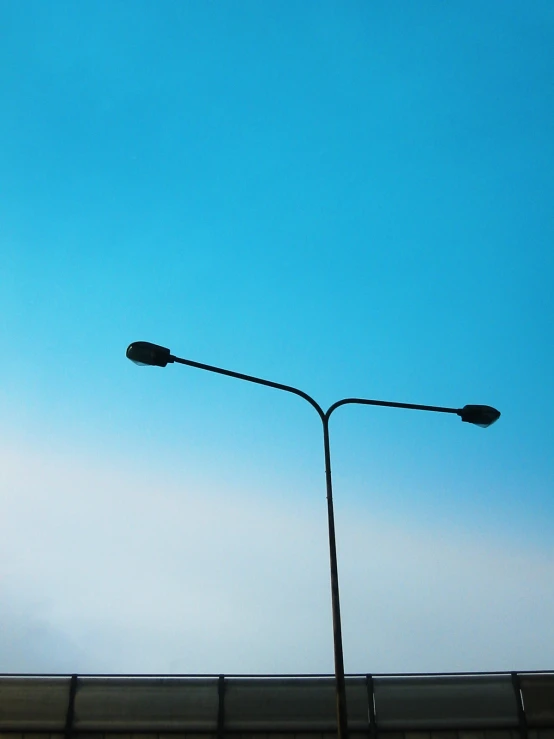 a street light sitting next to a tall building