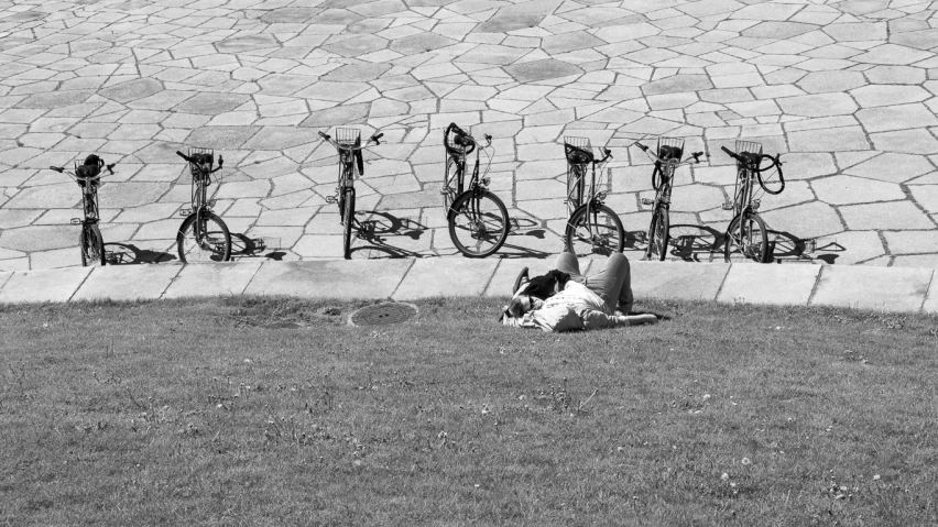 bicycles leaning against a brick wall in a park