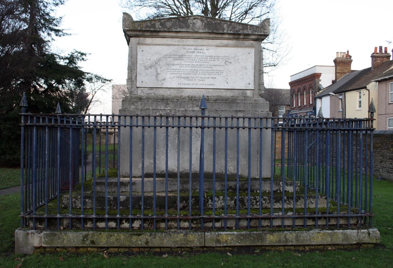 a small gate sitting in front of a cemetery