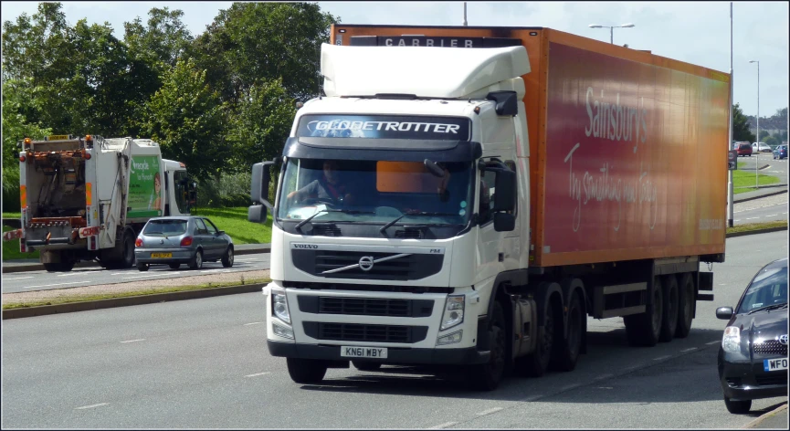 a truck that is next to a car on the road