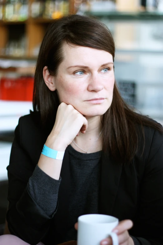 a close up of a person holding a mug