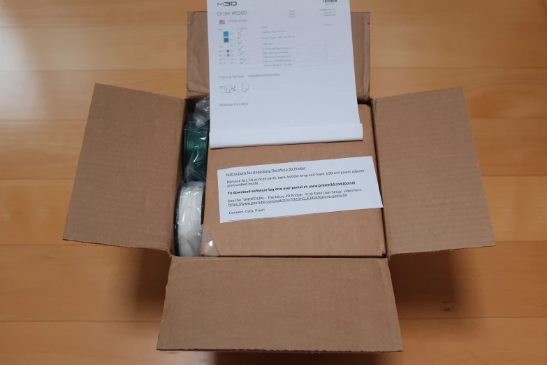 the inside of a box with papers on the desk