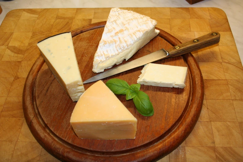 a cheese board with five different kinds of cheese