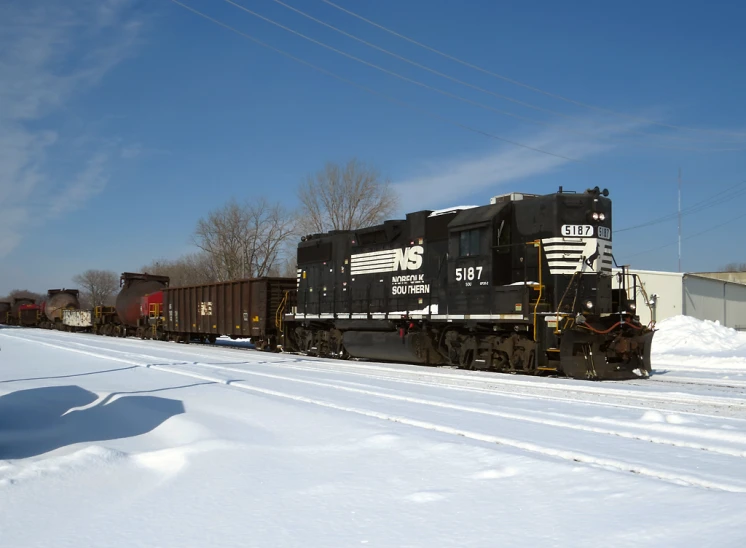 a train moving down the railroad on tracks