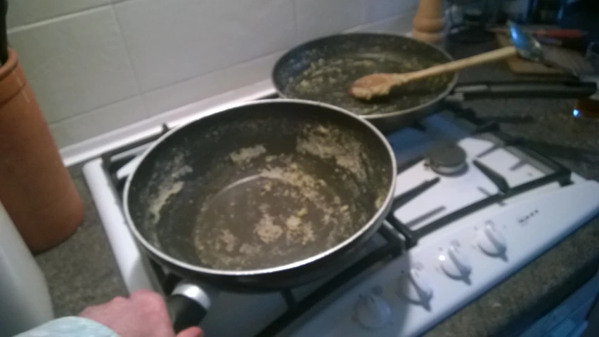 a man is stirring soing on a stove with a spatula