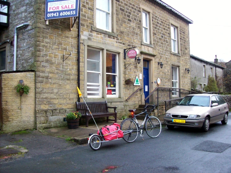 a car that is sitting next to a bike