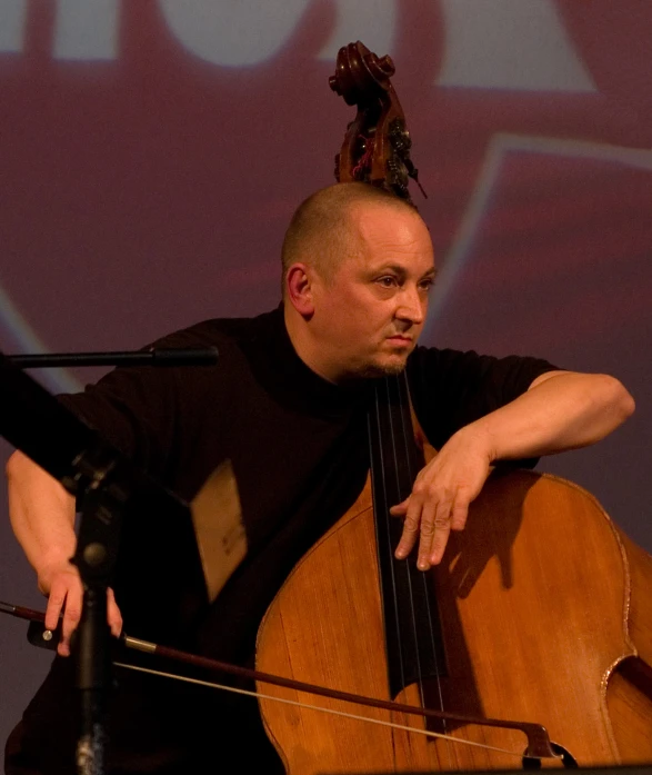 a musician is playing on an instrument while sitting