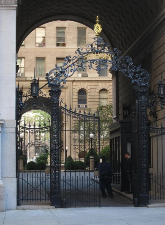 an ornate gate leads to the city street