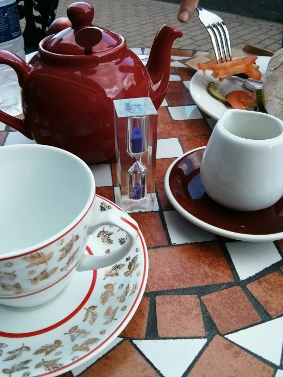 an assortment of teas and coffee cups with a saucer