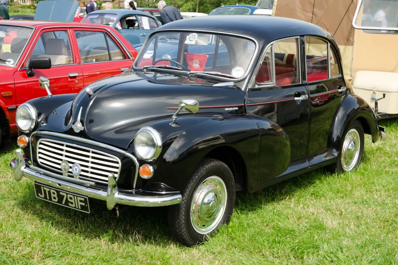 several cars sitting in the grass on display