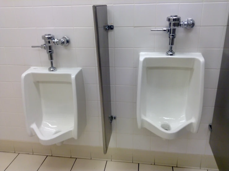 two urinals with mirrors on either side