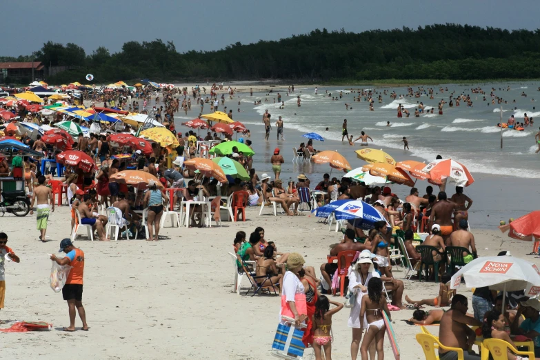 a beach full of people enjoying the sun