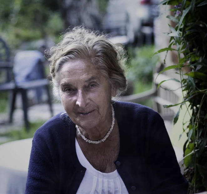 an older woman looking to the side with a concerned look on her face