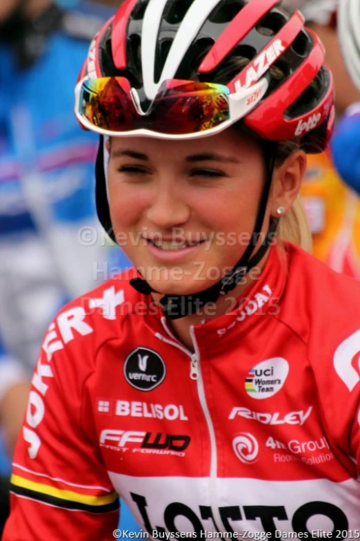 woman cyclist with helmet in front of spectators