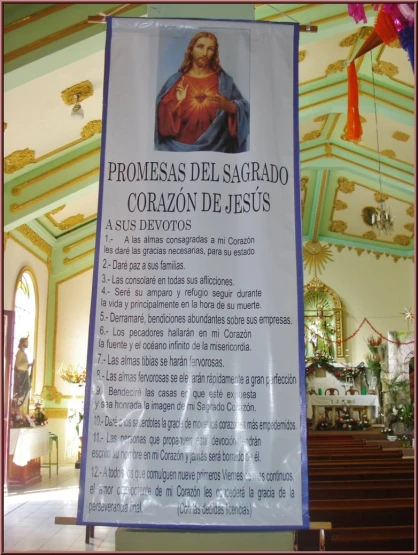 a sign with spanish and english words is placed next to a alter