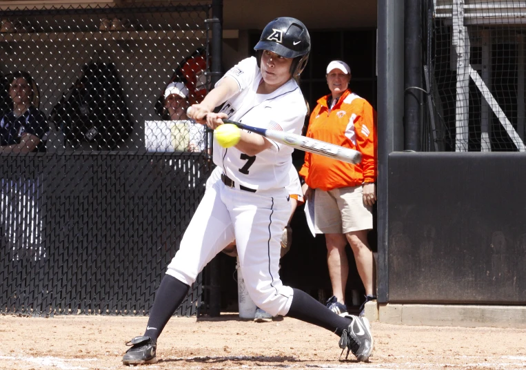 a baseball player swinging his bat at the ball