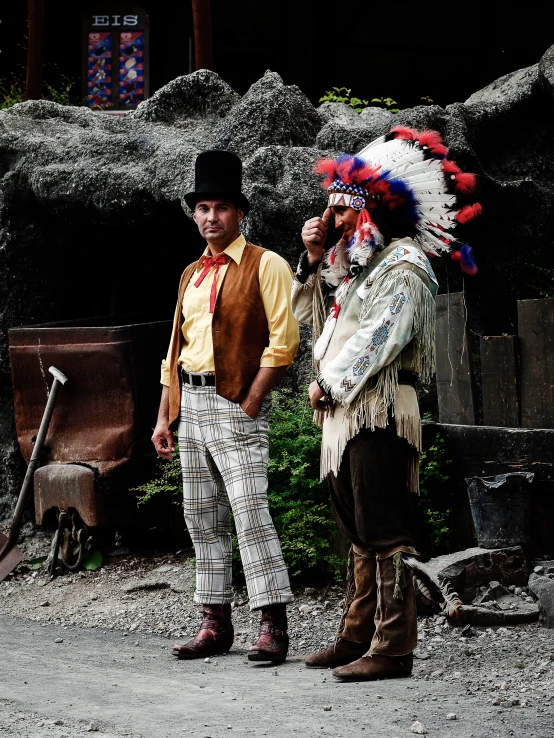 two people with elaborate costumes pose for a po