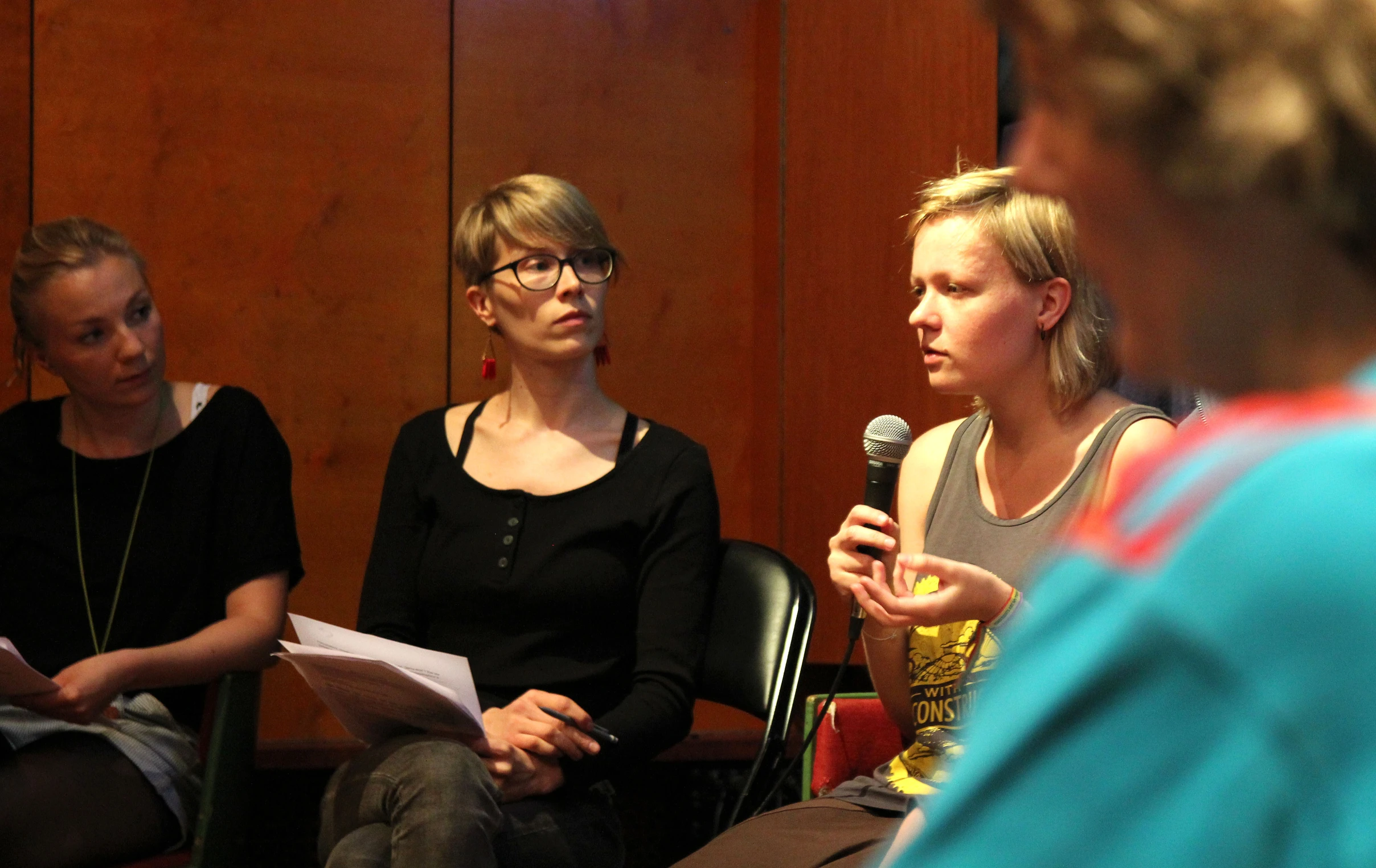 two women and a man sitting in chairs talking