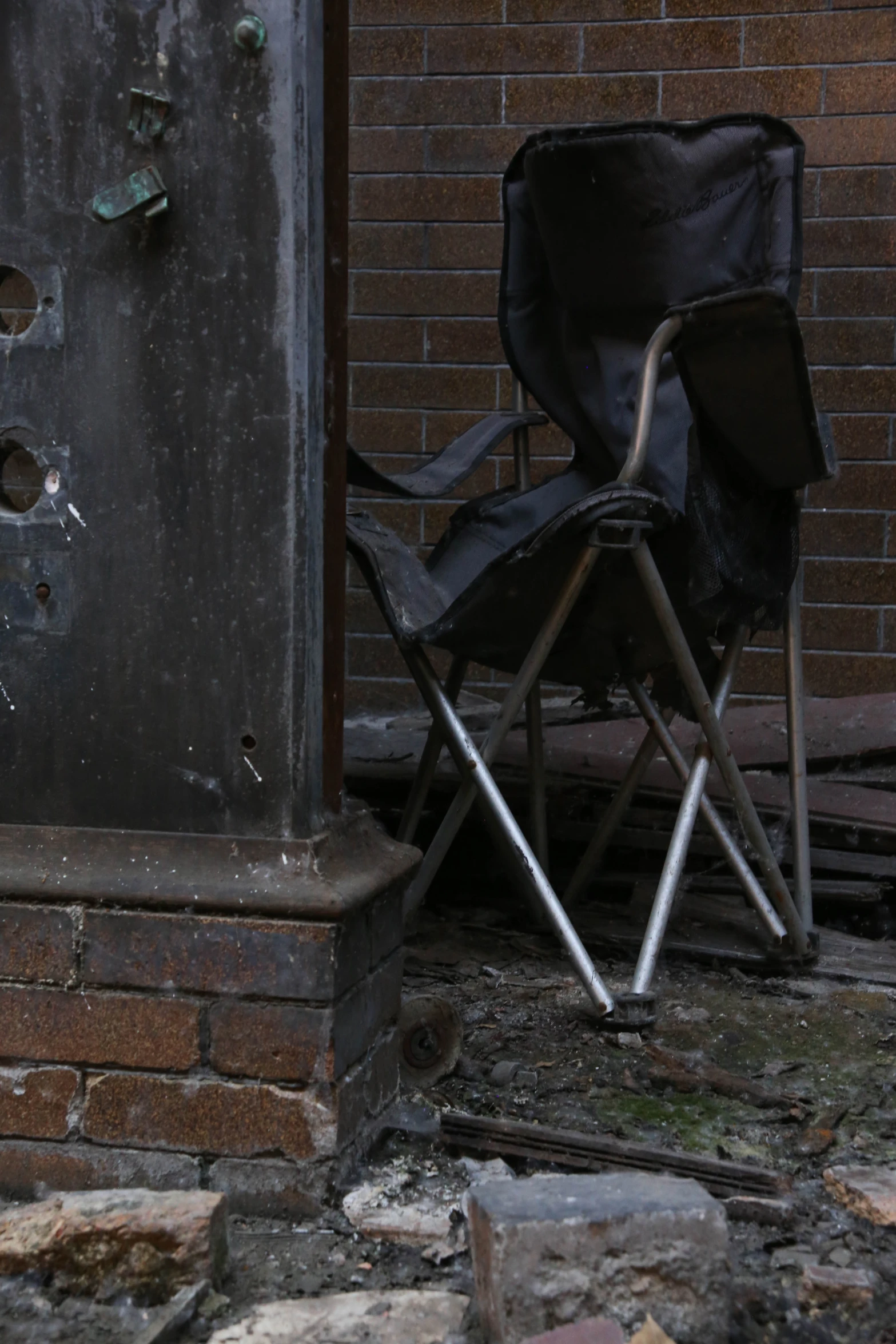 an empty folding chair is shown next to the broken door