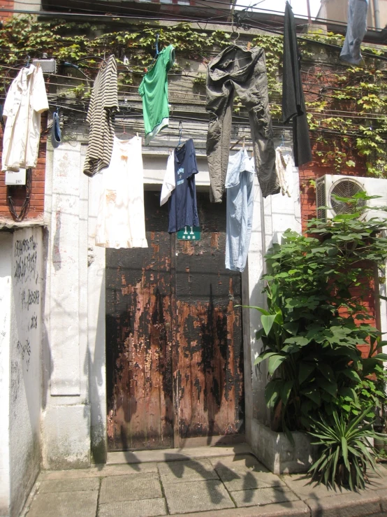clothes hanging on a line next to an old building