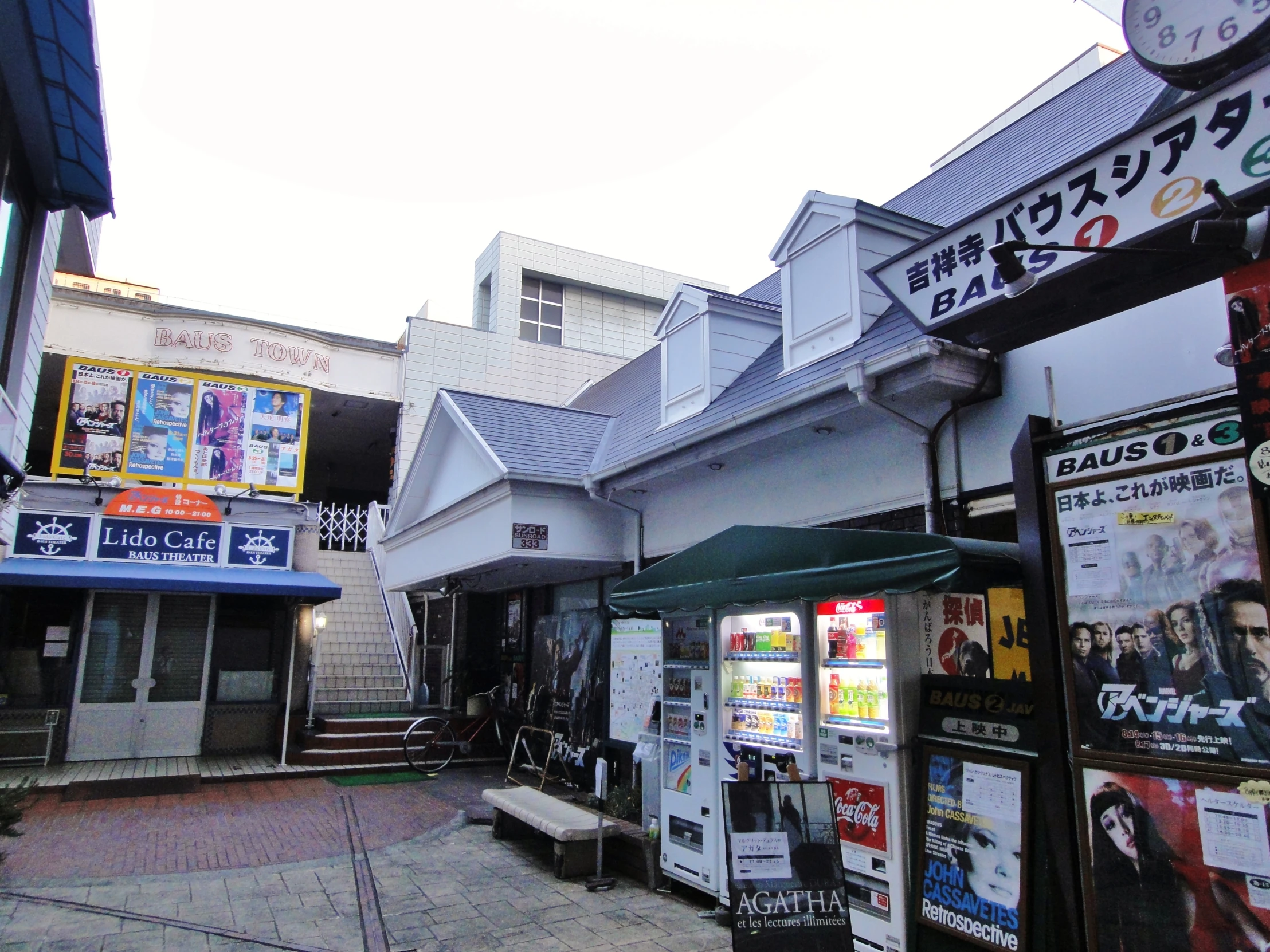 a street with many advertising signs and buildings