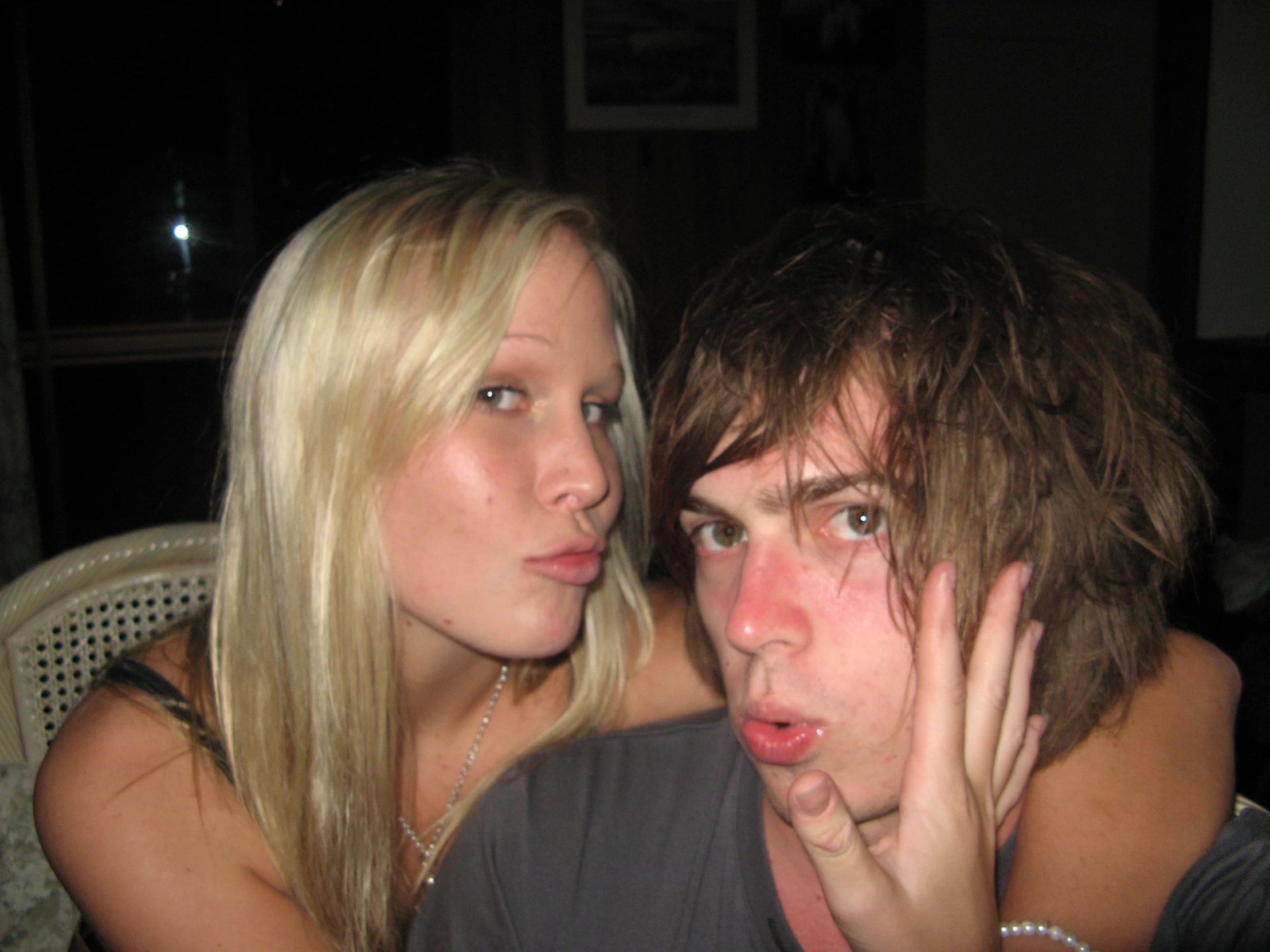 young man sitting next to woman with a suspicious look on her face