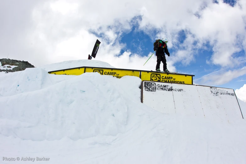 a skier rides down a snowy jump