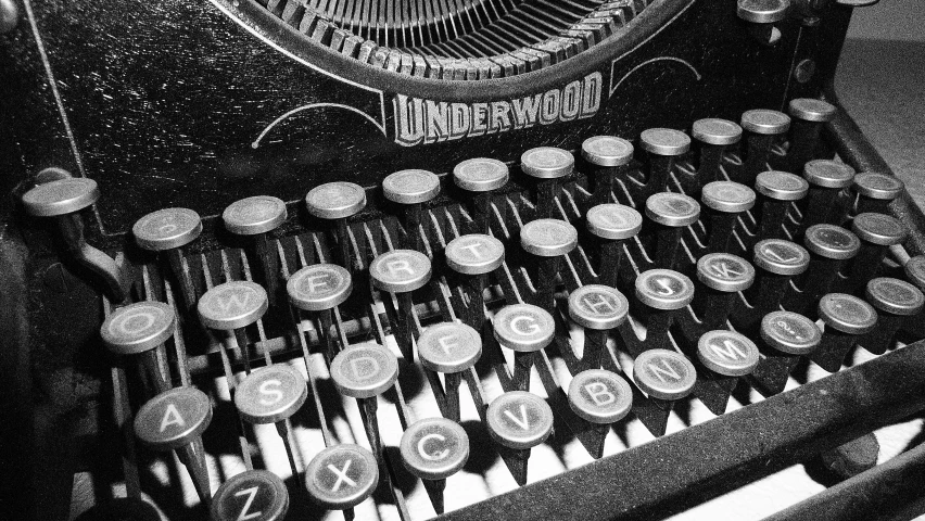 black and white image of a typewriter with keys
