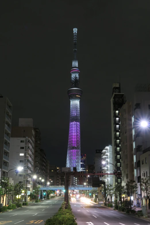 a building lit up purple and white in the night