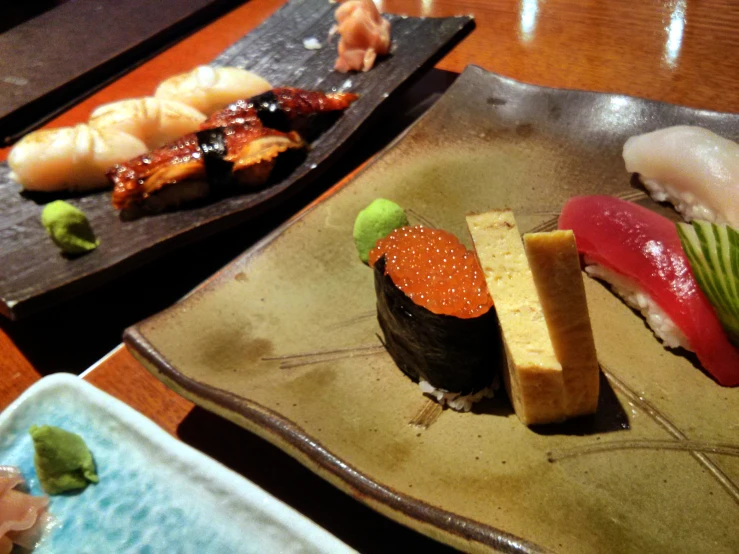 the sushi plate is decorated with various types of vegetables