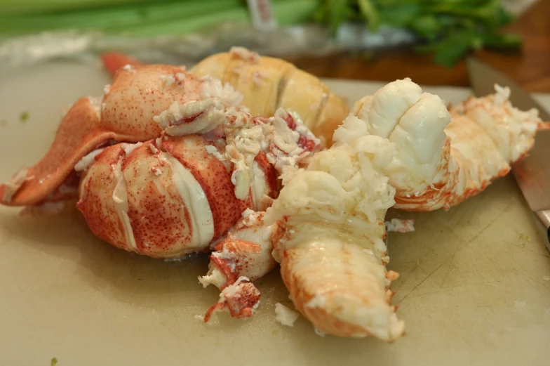 a pile of crab meat next to a knife