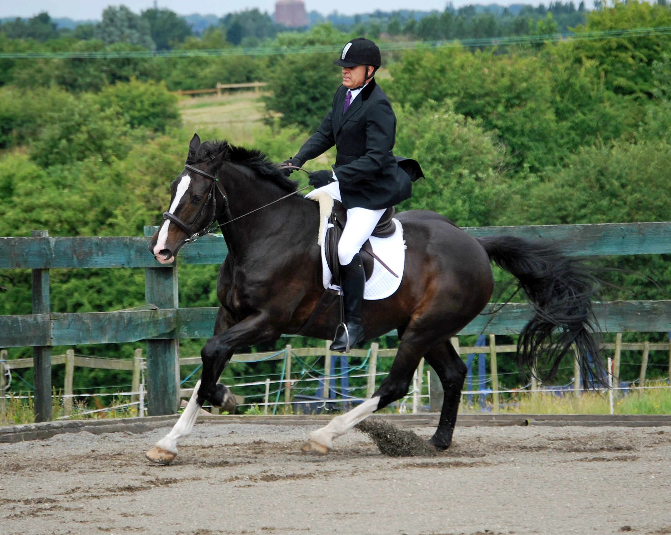 a jockey riding a horse, on a course