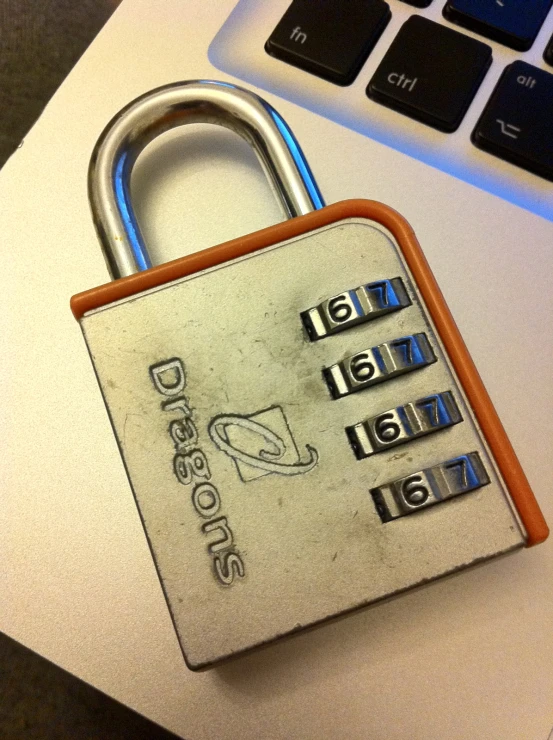 a combination lock is placed over a computer keyboard