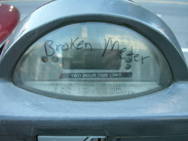 a coin meter sitting on the side of the street