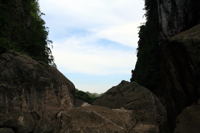 a person with a canoe stands among some rocky terrain