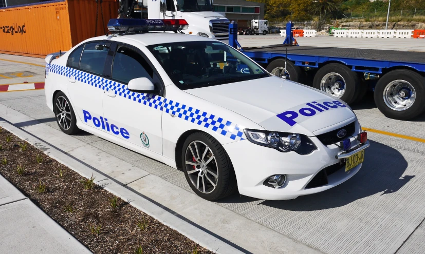 a police car parked next to an airport terminal