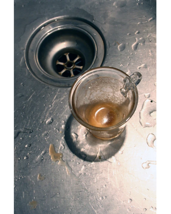 a cup of tea on a metal sink