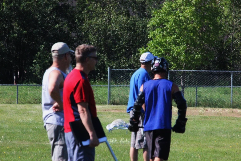 the boys are in the field playing a game of lacrosse