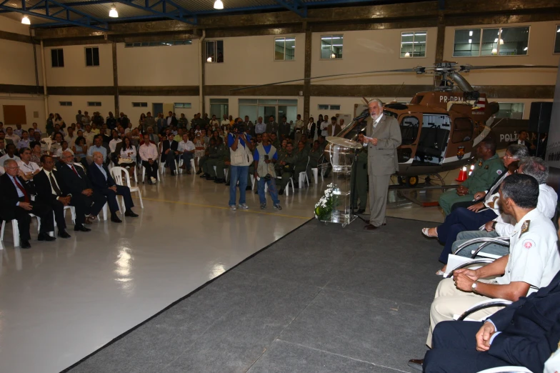 the audience of people are watching a speaker