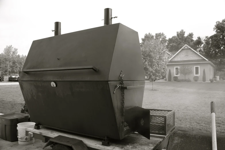 a big barbecue on top of a wooden truck