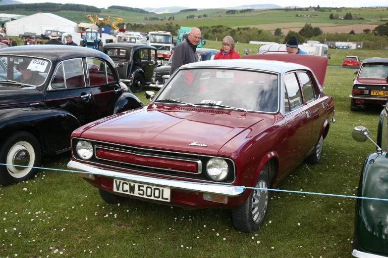 several classic cars parked at an auto show