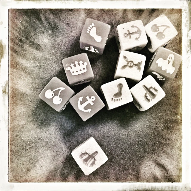 black and white image of six square and one regular dice