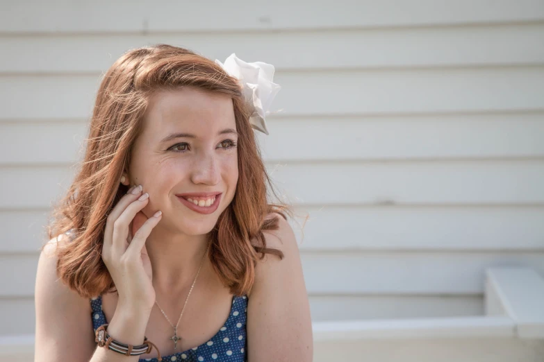 a woman that is smiling holding a cell phone