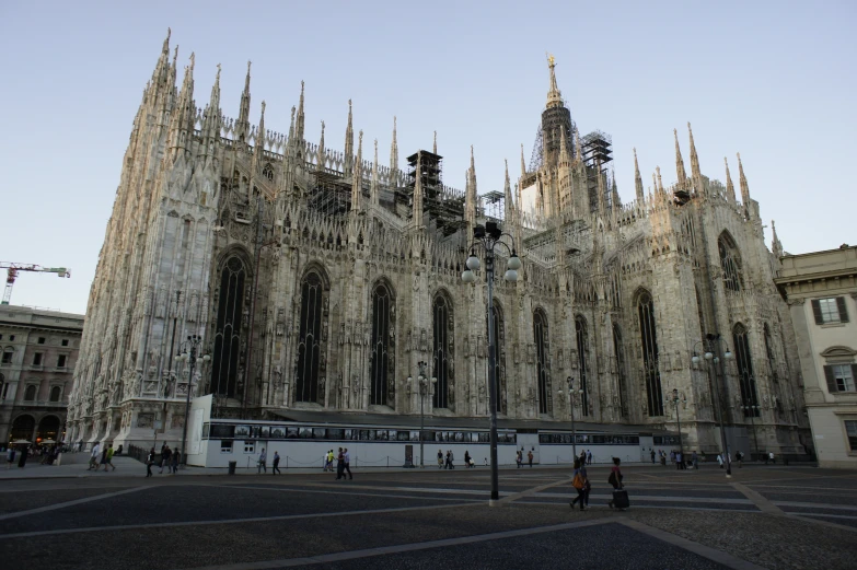 large gothic building with people walking in the street