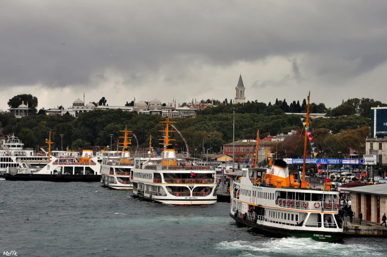 several boats that are next to each other in the water