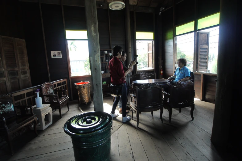 a girl sitting on a chair in an old looking room