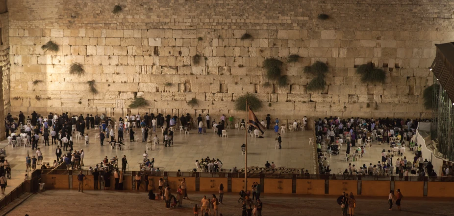 an overhead view of a crowd of people near a wall