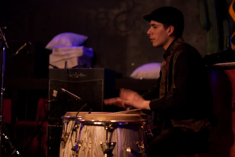 the drum player plays in his band with other instruments