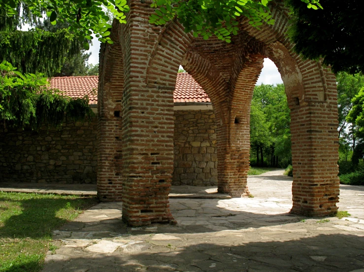 several arches of red brick sitting on some brick