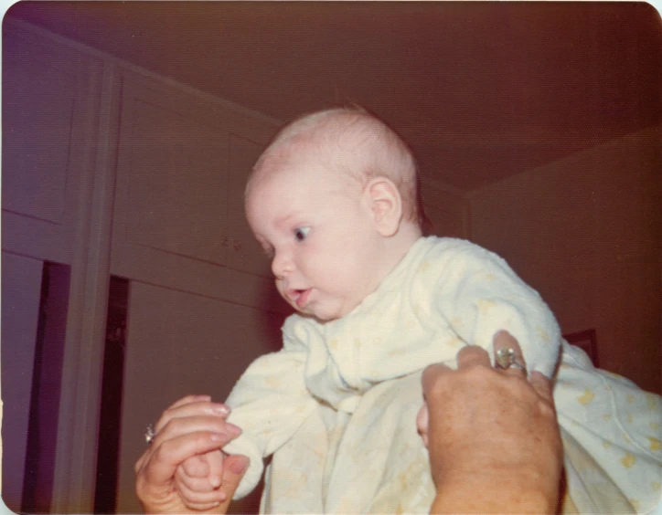 a man holding a baby in his arms